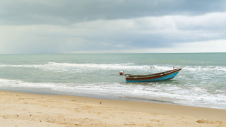 Stormy beach boat person sand - stormy weather free wallpaper