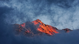 Mountain red peak clouds sunset - a dark sky in the background free wallpaper