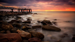 Pier sunset ocean rocks mountain - sunset over the ocean free wallpaper