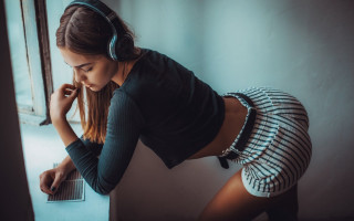 Woman leaning headphones laptop serious - headphone free wallpaper