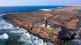 Lighthouse rocky island ocean waves 2 - aerial free wallpaper for desktop