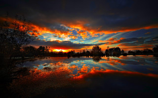 Sunset reflecting lake trees clouds - over a lake free wallpaper