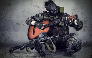 Man gasmask playing guitar sitting - grunge free wallpaper