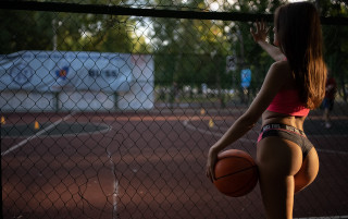 Athletic woman basketball court fence - a truck in the background free wallpaper
