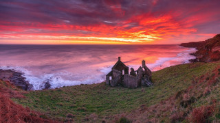 Sunset cliff grassy field water - stunning free wallpaper