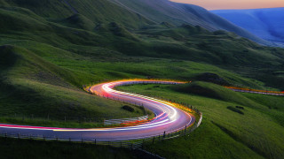 Winding road car light trail - rim light free wallpaper