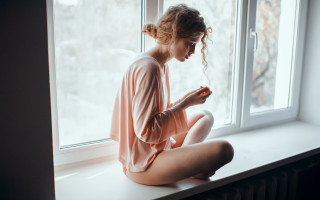 Woman sitting window snow romanticism - soft light free wallpaper