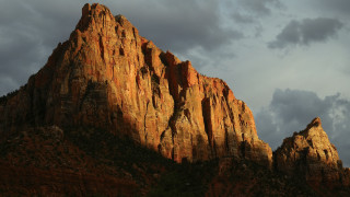 Mountain rockface cloudy sky evening - rim light free wallpaper