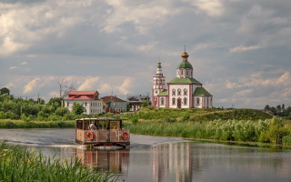 Boat river church cloudy sky - a church free wallpaper