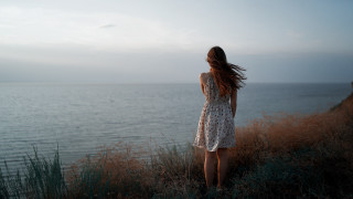 Woman cliff ocean wind dress - distant free wallpaper