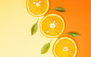 Three oranges leaves yellow background - a half free wallpaper for desktop