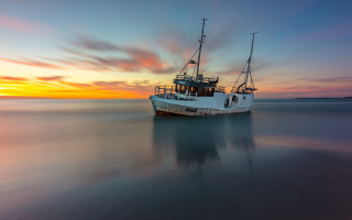 Boat sunset reflection colorful sky - a boat free wallpaper