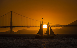 Sailboat ocean sunset bridge horizon - american romanticism free wallpaper