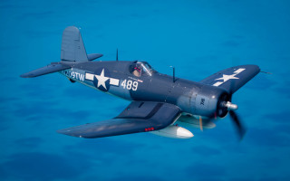 Blue white airplane over ocean - over the ocean water free wallpaper