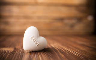 White heart on wooden table - a white heart free wallpaper
