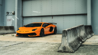 Bright orange sports car garage - concrete free wallpaper