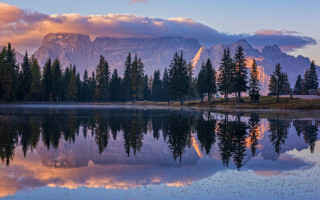 Mountain reflection lake trees sunset - the foreground and a mountain range in the background free wallpaper