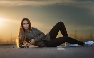 Woman laying sunset portrait brown - the sun in the background free wallpaper