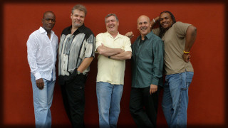 Men group red wall smiling - david simpson free wallpaper