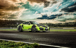 Green sports car cloudy sky 2 - a green grass area free wallpaper