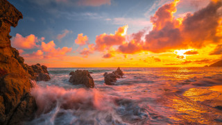 Sunset ocean rocks colorful clouds - the foreground and a body of water free wallpaper