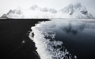 Black sand beach mountain water - low free wallpaper