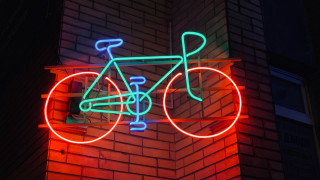 Neon bicycle brick wall night - a brick building free wallpaper