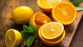 Cuttingboard sliced oranges lemons leaves - a cutting board free wallpaper