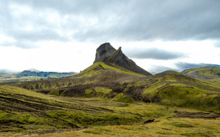 Mountain grassy field cloudy sky 2 - a grassy field below free wallpaper