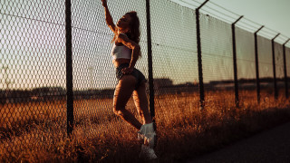Woman tennis fence sunset honeycomb - her leg up free wallpaper