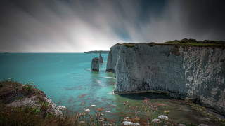 Cliff water boat mountain sky - a large cliff free wallpaper