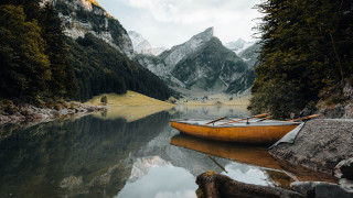 Canoe shore lake mountains cloudy - a canoe free wallpaper