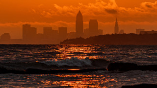 City skyline ocean sunset waves - cleve gray free wallpaper