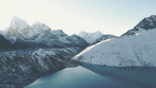 Mountain range lake snow blue - a lake in the middle of it free wallpaper