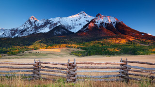 Fence mountain range field forest - a forest in the background free wallpaper