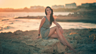 Woman sitting rock ocean sunset - sunrise time free wallpaper