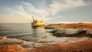 Large boat rocky shore cliff - photography free wallpaper