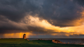 Lighthouse field stormy sky ocean - free rain wallpaper