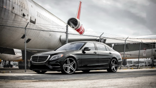 Black mercedes plane runway cloudy - a cloudy sky behind free wallpaper