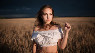 Wheat field woman crossed arms - a sky in the background free wallpaper