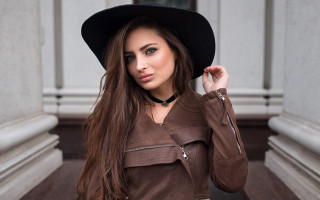 Woman brownjacket blackhat portrait bookshelf - a brown jacket free wallpaper