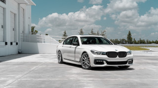 White car building clouds sky - a white car free wallpaper