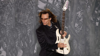 Black suit man white guitar - a forest background free wallpaper