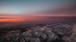 Mountain range sunset pink sky 5 - an airplane window free wallpaper for desktop