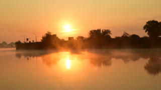Foggy lake sunset trees building - a building in the distance free wallpaper