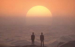 Sunset ocean rocky beach silhouettes - a hazy sky free wallpaper