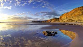 Rock water beach clouds mountains - widescreen free wallpaper