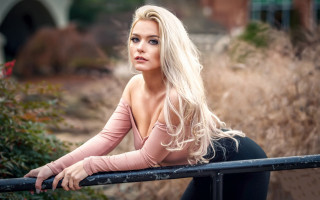Blonde woman leaning rail portrait - a rail free wallpaper