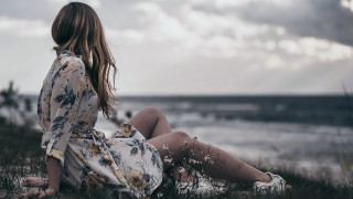 Woman sitting grass looking water - woman free wallpaper