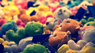 Stuffed animals pile tags table - a tilt shift photo free wallpaper